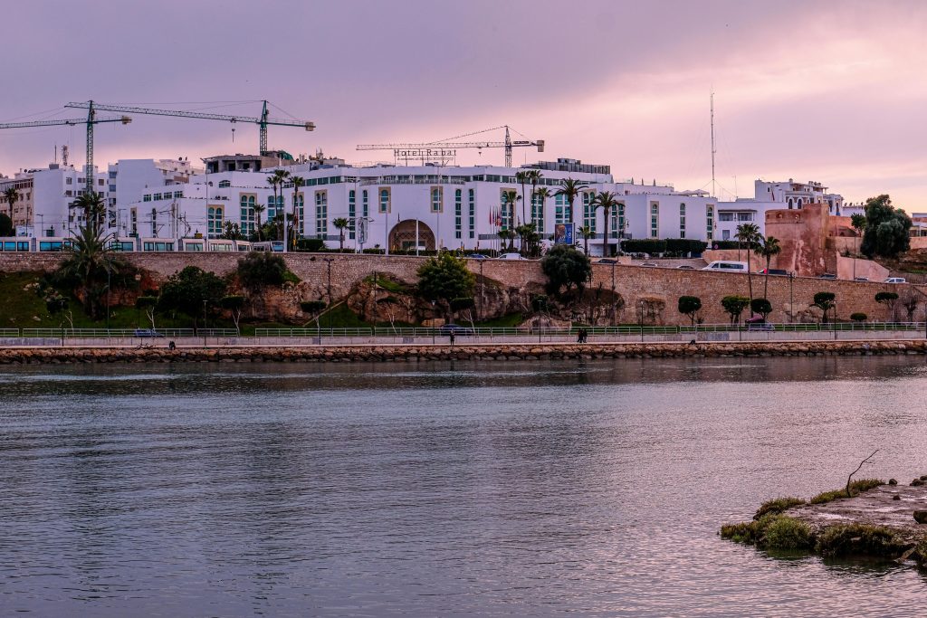 Scenic view of Rabat's architecture by the river at sunset.